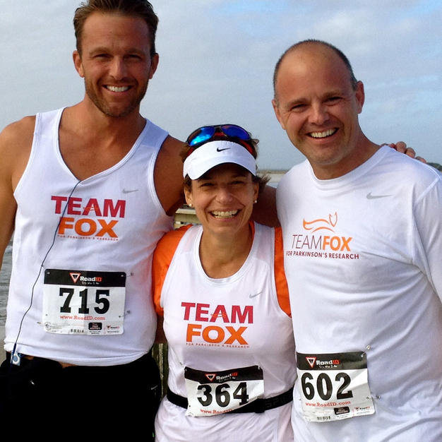 Three Team Fox athletes posing for camera on the beach.