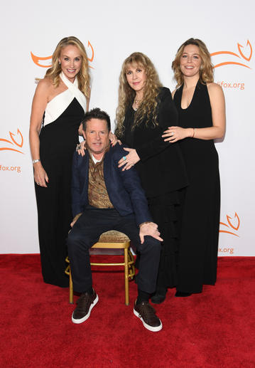 Michael J. Fox, Tracy Pollan, Stevie Nicks and Maggie Rogers pose on the red carpet. 