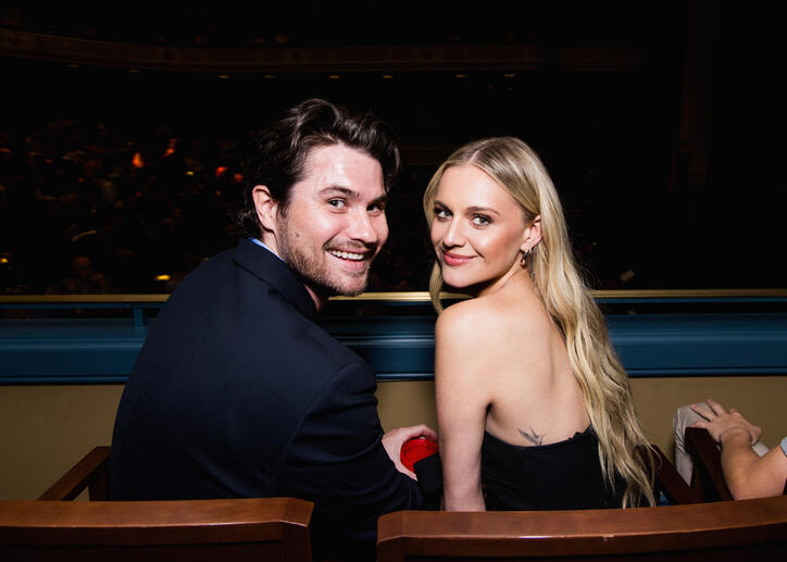 Kelsea Ballerini and Chase Stokes pose for a picture in their seats.
