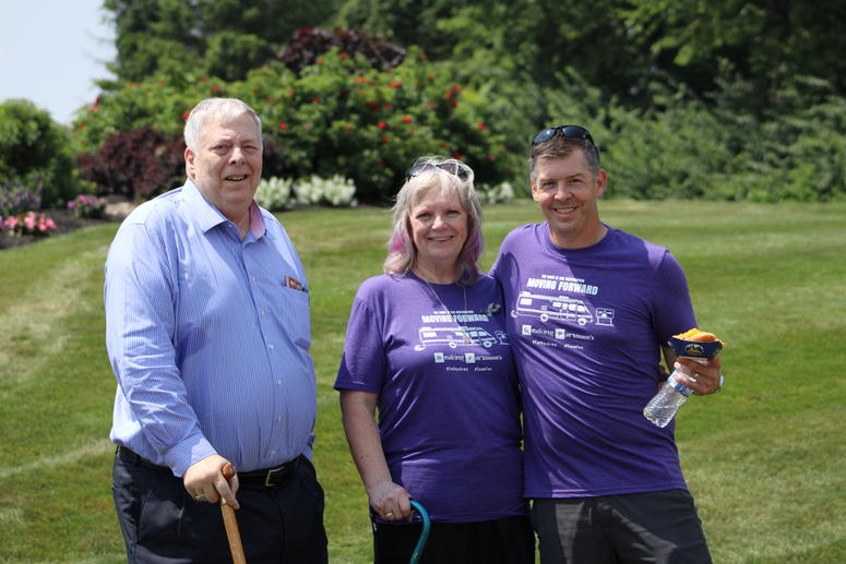 Eric posing with Cathy and Greg Rhodes on the green