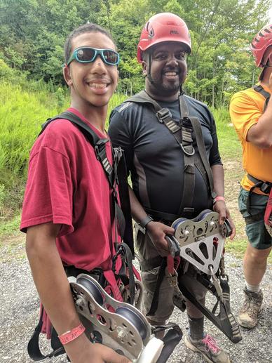 Eric conquering his fear of heights and ziplining at a Boy Scout camp in West Virginia with his son.