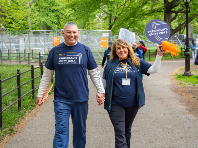 A couple walks hand in hand at the 2026 Parkinson's Unity Walk.
