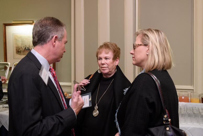 Carol Walton speaking with others.