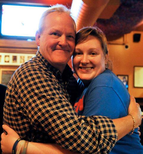 Kate smiling and hugging her late father, Bob Harmon.