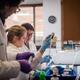 A trio of researchers working at lab bench.