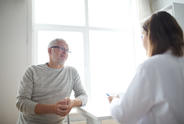 Patient speaks with doctor in an office