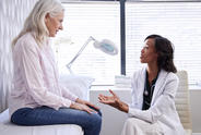 Patient on bed speaking to a doctor