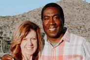 Man and woman smiling at camera.