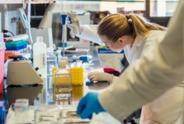 Female researcher in lab with tool.