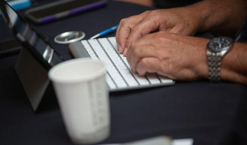 Hands typing on a keyboard