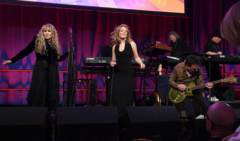 Stevie Nicks, Maggie Rogers and Michael J. Fox perform onstage. 