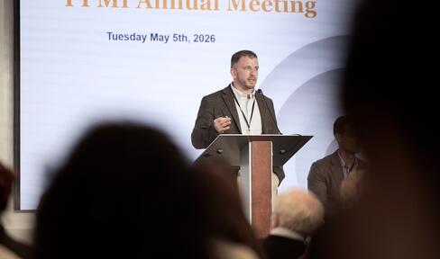 A man speaks at a podium.