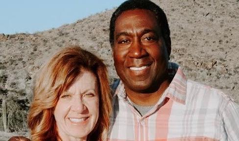 Man and woman smiling at camera.