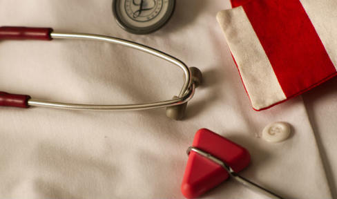 Doctor's white coat and red stethoscope.