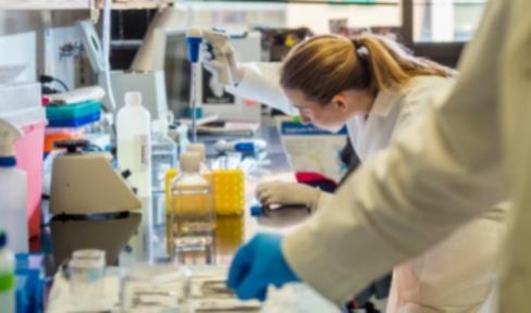 Female researcher in lab with tool.