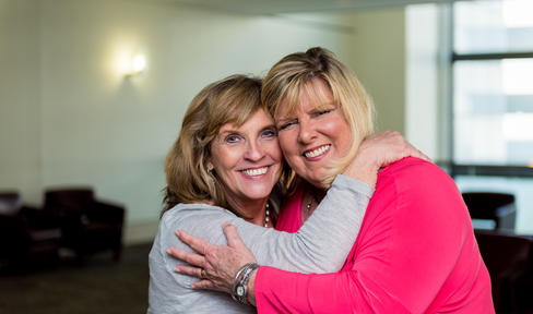 Two friends embracing.