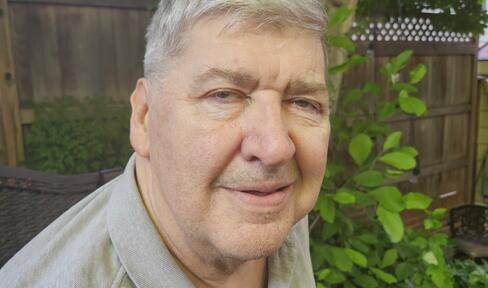 A photograph of Jim O'Connell smiling in a backyard.