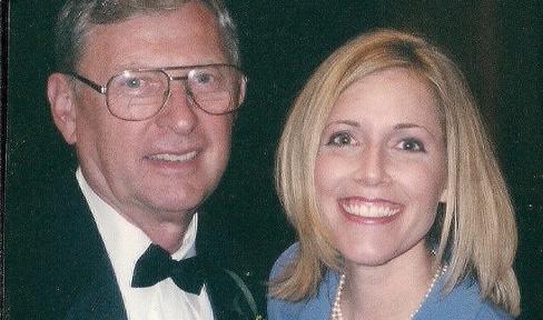 Man and woman smiling at camera.
