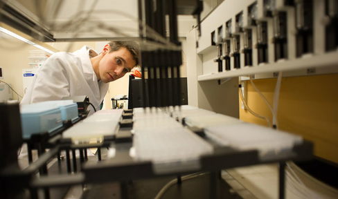Lab tech performs research in a lab