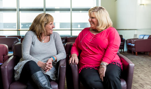 Two friends sitting in a doctor's office.
