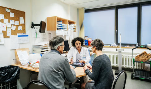 Three people talking at a clinic