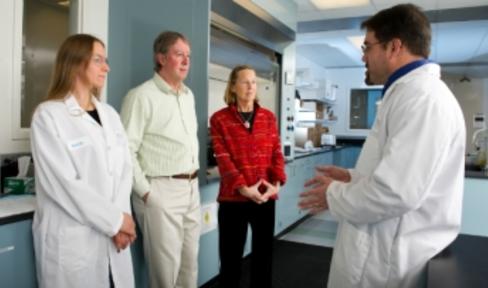 Researchers talking with patients