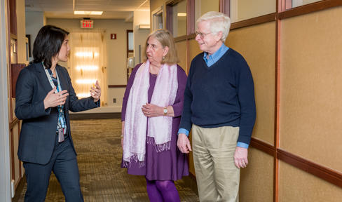 Three people talking at a clinic