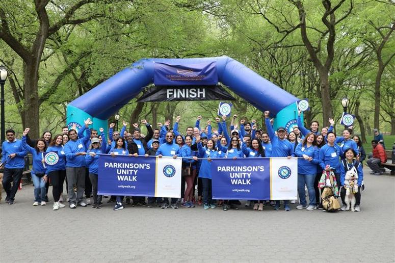 Parkinson's Unity Walk attendees gather at the finish line after walking together for a cure