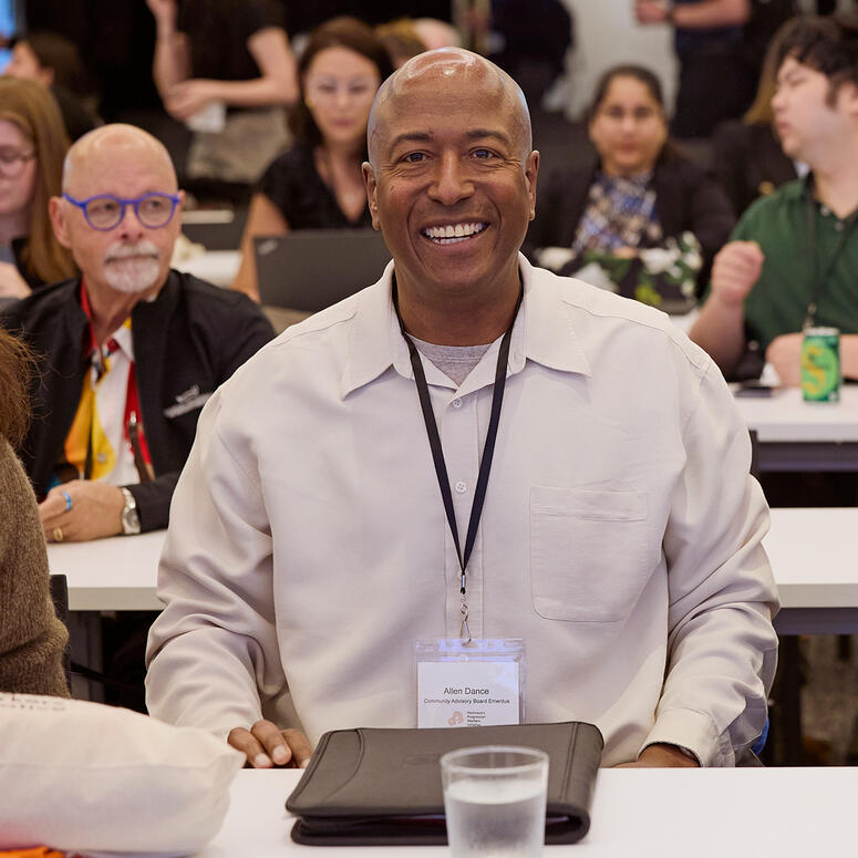 Allen Dance seated at a table during a conference