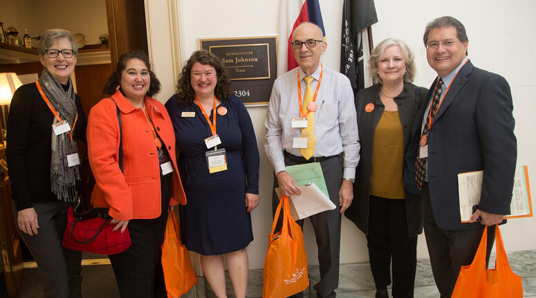 Israel Robledo and five others stand in a legislative building