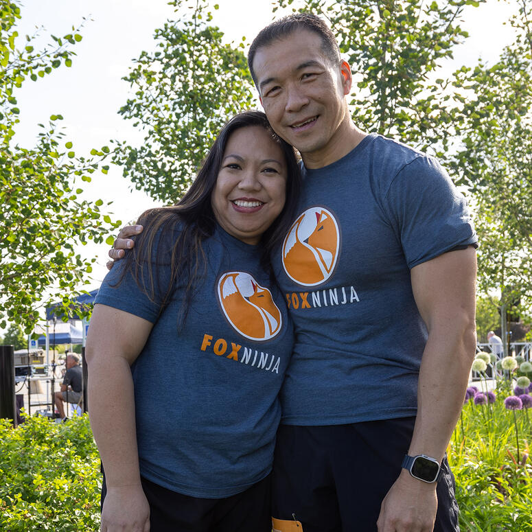 Jimmy Choi and wife Cherryl stand together wearing shirts that read Fox Ninja