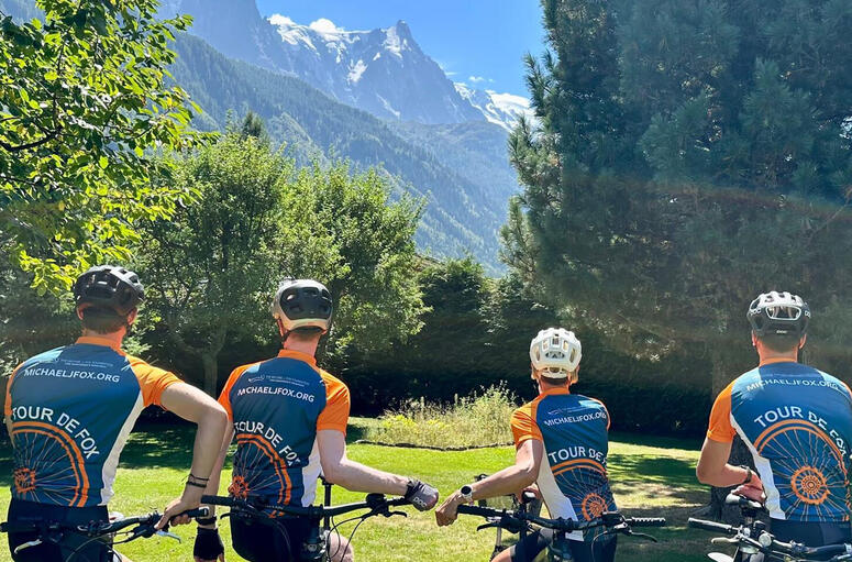 A group of cyclists for Team Fox show off their Tour de Fox jerseys looking out at the French Alps in Chamonix.