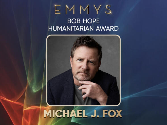 Promotional graphic for the Emmy’s Bob Hope Humanitarian Award featuring a portrait of Michael J. Fox on a blue background with light streaks.