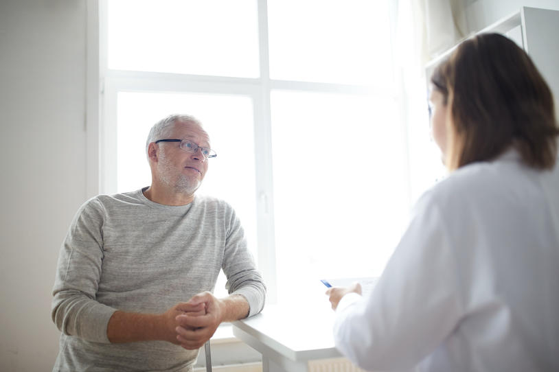 Patient speaks with doctor in an office