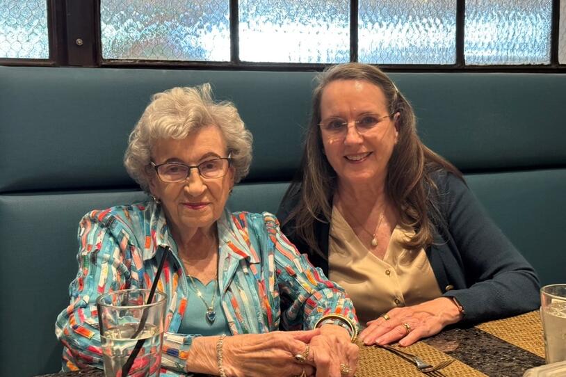 Celia and Pat sitting together in a booth.
