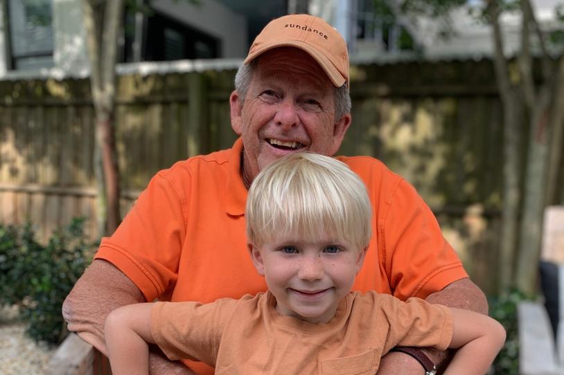 Chip holds his grandson, Teddy. 