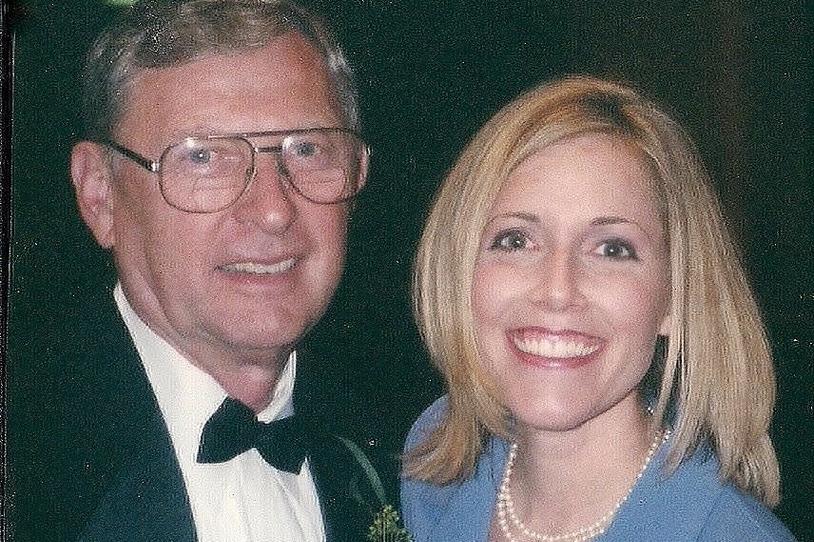 Man and woman smiling at camera.