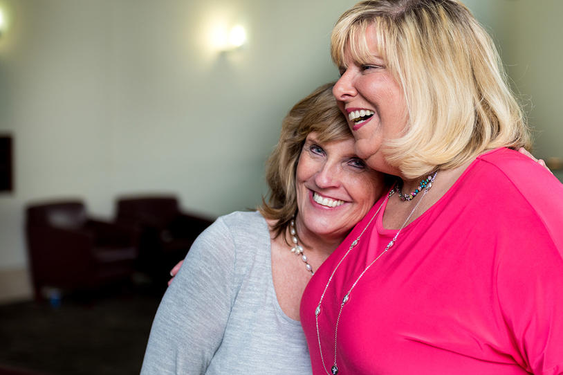 Two female friends embracing.