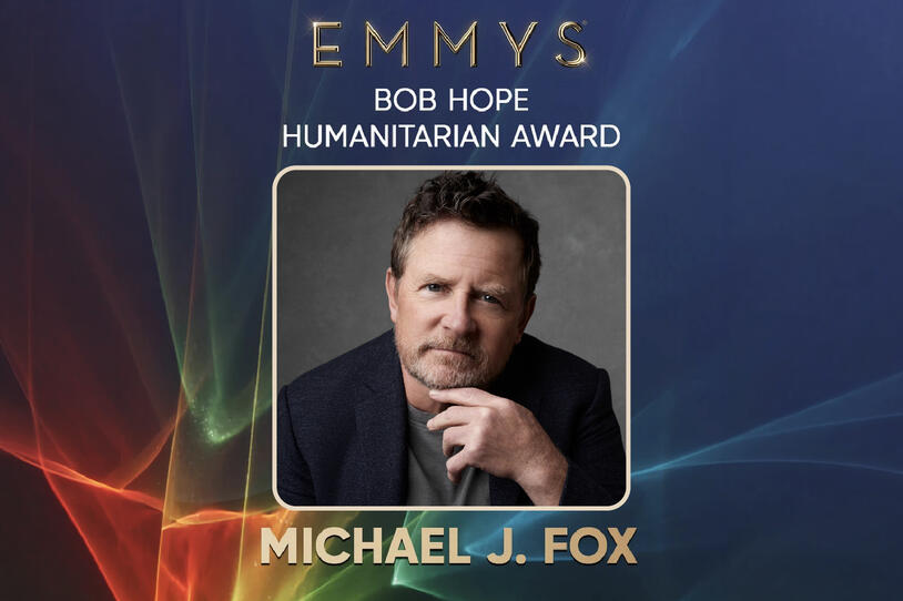 Promotional graphic for the Emmy’s Bob Hope Humanitarian Award featuring a portrait of Michael J. Fox on a blue background with light streaks.