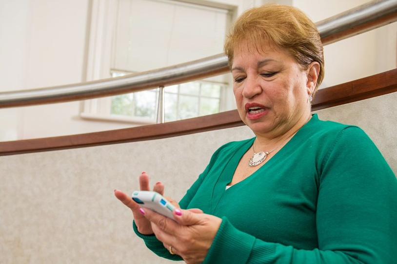 Woman looking down at her mobile phone.