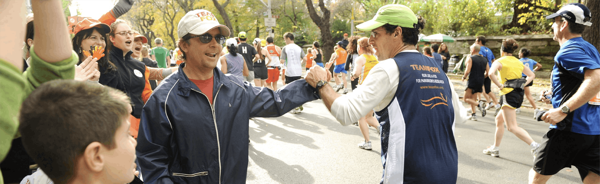 Michael J. Fox giving a high five to a runner