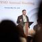 A man speaks at a podium.