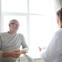 Patient speaks with doctor in an office