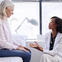 Patient on bed speaking to a doctor