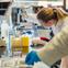 Female researcher in lab with tool.