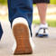 Two people wearing sneakers walking.