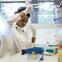 A researcher using a pipette while standing at a lab bench working in a research  laboratory.