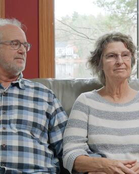 man and woman sitting on a couch