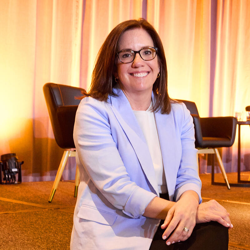 Allie Signorelli sits on a stage at a speaking event