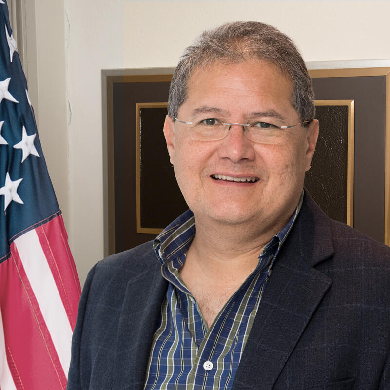 Man standing in front of American flag